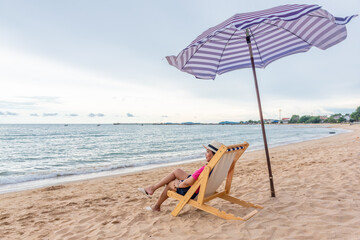 Traveler woman lying on the beach chair.