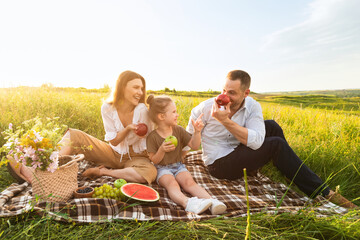 Wall Mural - Happy family playing together on a picnic outdoors