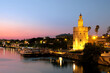 View of Golden Tower (Torre del Oro) of Seville, Andalusia, Spain by river Guadalquivir at sunset Torre del Oro of Seville by the Guadalquivir at sunset