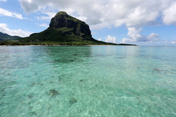 View of tropical island from the water with clear water.
