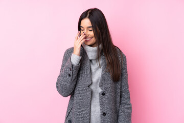 Wall Mural - Young brunette woman over isolated pink background smiling a lot