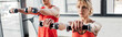 panoramic orientation of sport couple exercising with dumbbells in gym