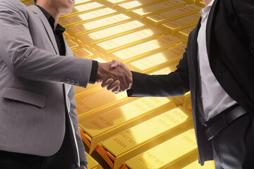 Two investors handshake of congratulations on the success of investing in gold.