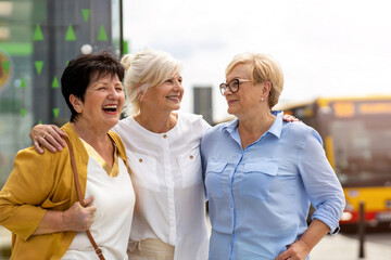 three senior female friends having good time together