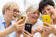 © pikselstock - Group of senior women using smartphones together