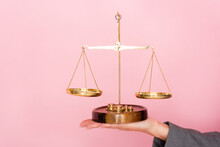 Cropped View Of Businesswoman Holding Golden Scales Isolated On Pink, Gender Equality Concept