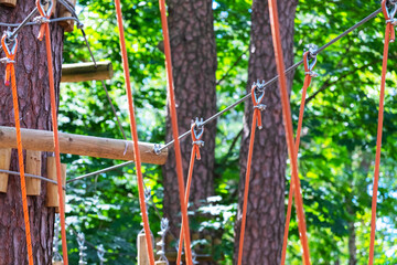 A bridge of logs tied to ropes, part of the rope route. Extreme sport.