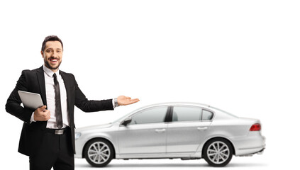 Poster - Car salesman holding a digital tabler and showing a silver new car