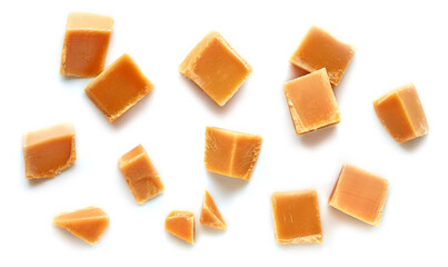 Wall Mural - caramel pieces on white background