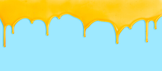 Honey dripping on blue background. Natural bee honey drip. Liquid dripping