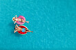 © New Africa - Happy couple with inflatable rings in swimming pool, top view and space for text. Summer vacation