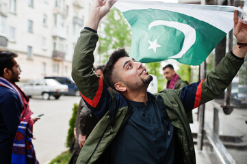 Wall Mural - Group of pakistani man wearing traditional clothes salwar kameez or kurta with Pakistan flags.