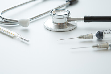 Selective focus of stethoscope , Syringes and thermometer  on a white background and copy space