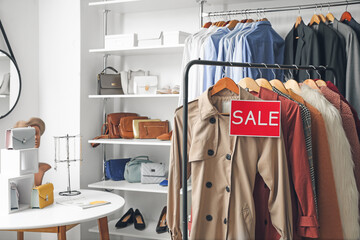 Sticker - Hanger with stylish clothes in modern store