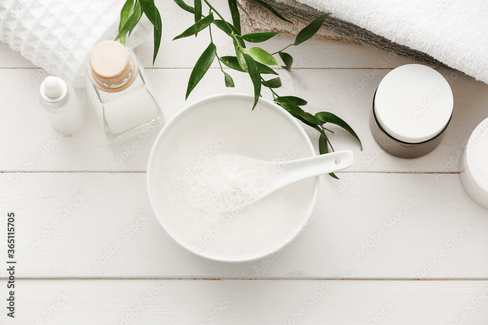 Healthy rice water with cosmetic supplies on table