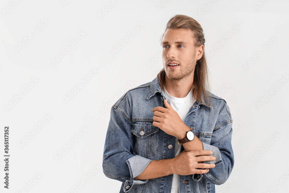 Handsome man with stylish hairdo on light background