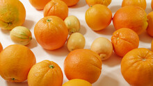 Oranges And Lemons On White Background. Fresh Ripe Fruits Close Up, View From Above.