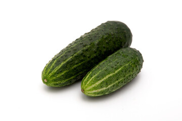 Wall Mural - Green cucumbers on  a white background. 