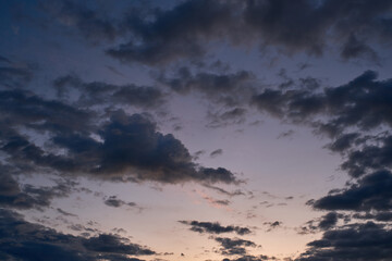 Sunrise on a background of dark gray clouds a shade of orange