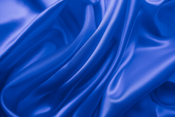 Beautiful elegant wavy classic blue satin silk luxury cloth fabric texture, abstract background design.