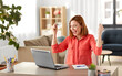 © Syda Productions - remote job, technology and people concept - happy smiling young woman with laptop computer working at home office and celebrating success