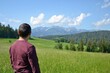© PaulSat - Tatra Mountains panorama near Bukowina Tatrzanska. Unidentified man looking at gorgeous mountain range with high rocky peaks and green farming fields in sunny summer day, Podhale, Poland