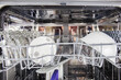 © HappyLenses - Close up of stacked plates in modern dishwasher for freshly cleansed kitchenware to be used in everyday housework and housekeeping