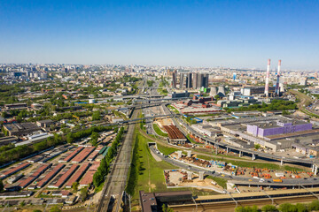 Wall Mural - Power plant pipes and cooling towers in Moscow from above, automobile traffic and the old Ugreshskaya railway station in the Moscow industrial zone near the automobile ring highway.