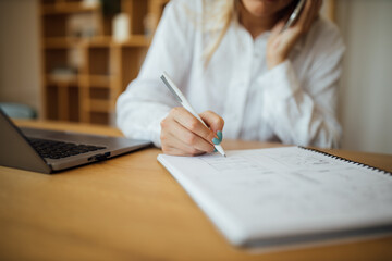 Wall Mural - Women writing with pen in notebook.