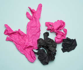 Wall Mural - black and pink latex gloves on a blue background