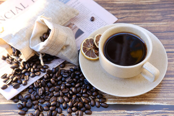 Poster - Top view coffee cup and coffee beans on wood table, space for text