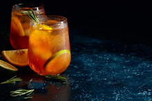 Traditional Iced Tea With Lemon, Lime And Ice Garnished With Rosemary Twigs.