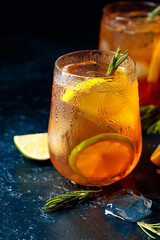 Wall Mural - Traditional iced tea with lemon, lime and ice garnished with rosemary twigs.