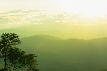 Wall Mural - sunset and mountains interspersed with green grass