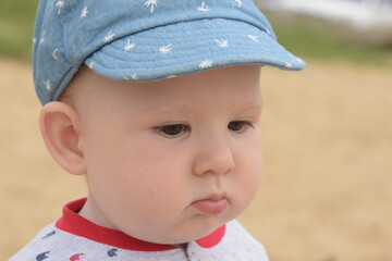 Toddler boy sitting on the sand