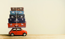 Suitcase On Toy Car Roof In Retro Style Creative Travel Concept.