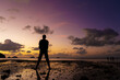 © Kate - Silhouette of a man on the beach at sunset. Man rejoices meets the sunset