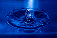 Close-up Of Drop Falling On Blue Water