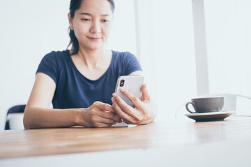 using cell phone.woman holding texting message on screen mobile chatting,search internet information sitting in office.technology device contact communication connecting people concept