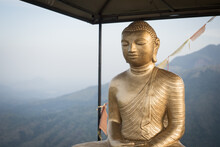Golden Buddha Statue Against Mountain Range Against Sky