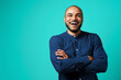 © fotofabrika - Joyful dark-skinned man laughing against turquoise background