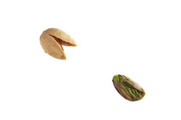 Roasted salted pistachio nut outside of his shell with salt crystals on a white table background