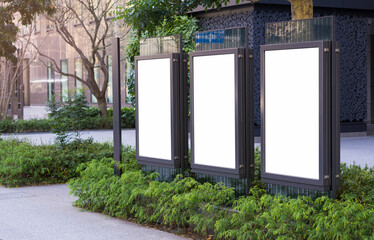 Wall Mural - Three vertical billboards on the city streets