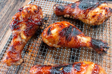 Wall Mural - air fried barbecued chicken legs with glaze on wire rack