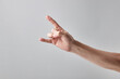© Andrii - caucasian male person showing hard music horn symbol. isolated over grey background. music in our life concept.