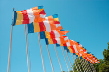 Row Of Buddhist Flags Fluttering On Blue Sky