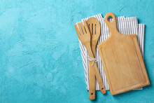 Napkin, Cutlery And Cutting Board On Blue Background, Space For Text