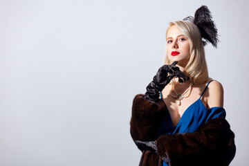 Poster - Blonde woman in vintage blue dress and fur coat with opera glasses