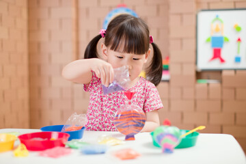 toddler girl making sand animal crafts for homeschooling