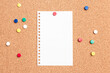 © Colozio - Flat lay of a blank paper with a red thumb tack holding it on a cork board with multi colored thumb tacks around